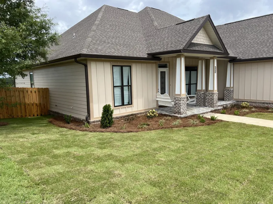 New home with fresh lawn and front beds
